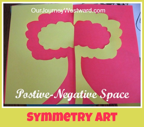 Positive and negative space art project with green and red paper turned into a tree.