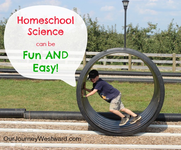 Boy in a giant plastic pipe spins it on a track. For a blog post about homeschool science that is fun and easy.