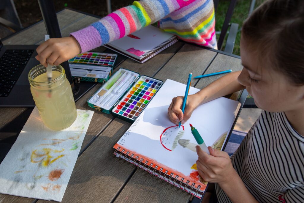 children painting in nature journals