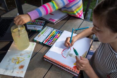 children painting in nature journals