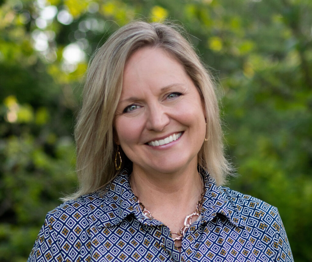 Cindy West in a blue dress outside